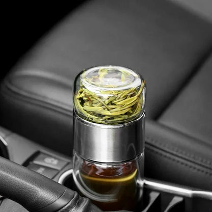 Clear double-compartment storage bottle with silver base, filled with green herbs