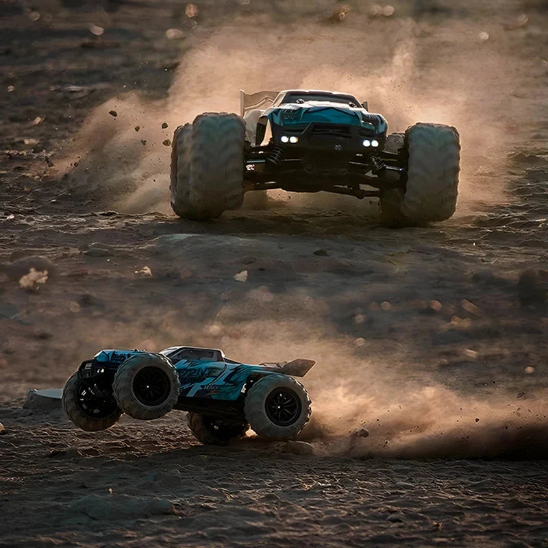 Teal and black 4WD monster RC truck driving through dust with LED headlights
