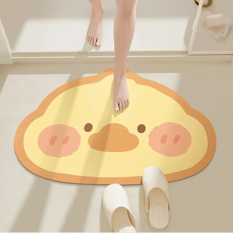 Round bathroom floor mat with cute chick face in yellow and orange tones