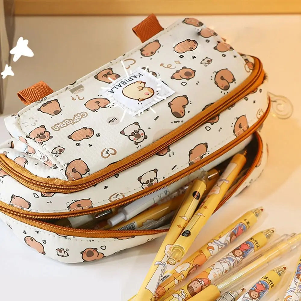 Side view of capybara print pencil bag with open zipper and colored pens inside