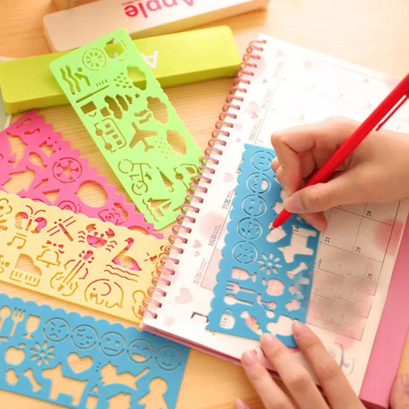 Kids drawing templates and plastic stencils used on a lined notebook page
