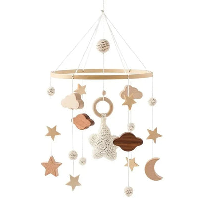 Wooden crib mobile with hanging stars, clouds, moon, and rattle beads on frame