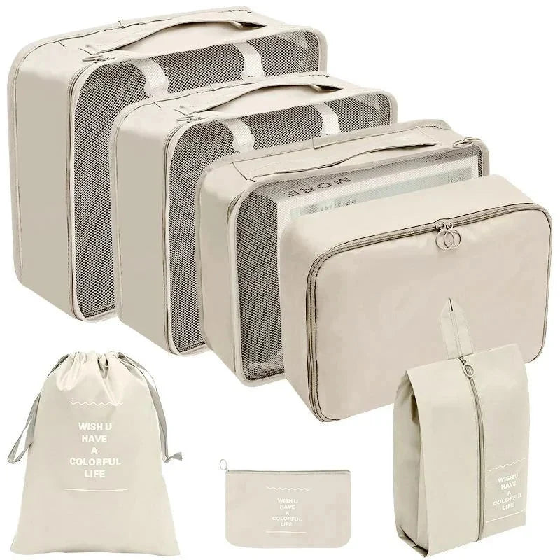 Beige packing cubes set with mesh panels and zippered compartments for travel storage.