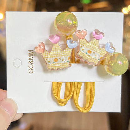 Yellow elastic hair ties with crown and heart charms and iridescent ball bead accents