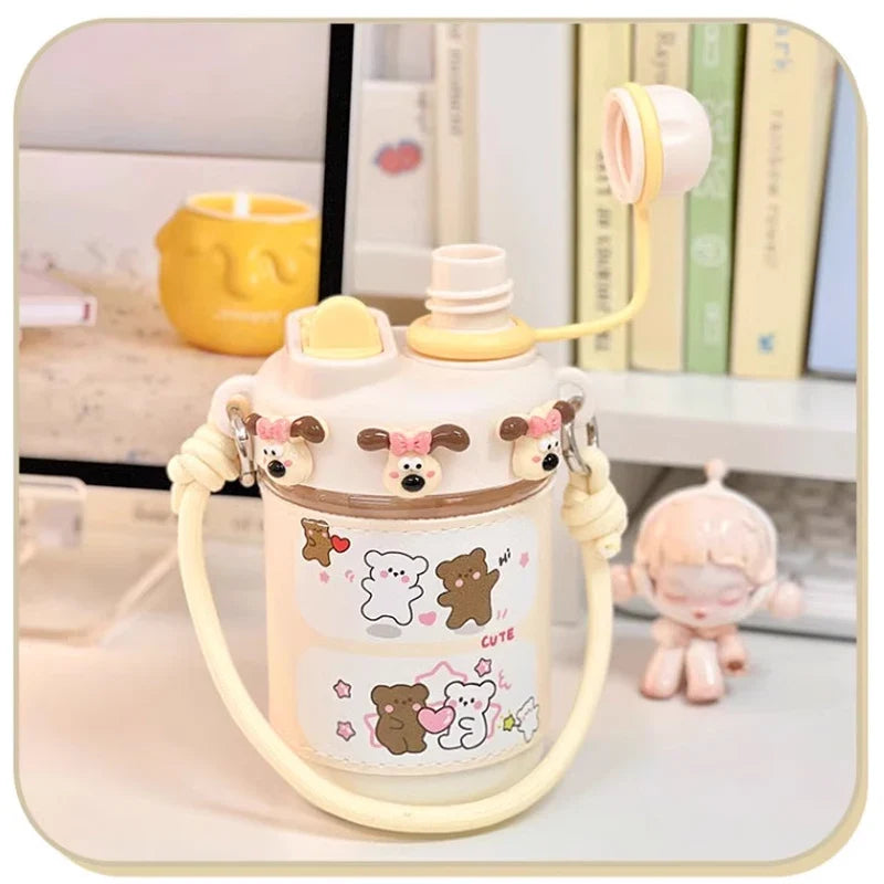 Cream kids water bottle with straw lid and white strap, cute bear and cat character print