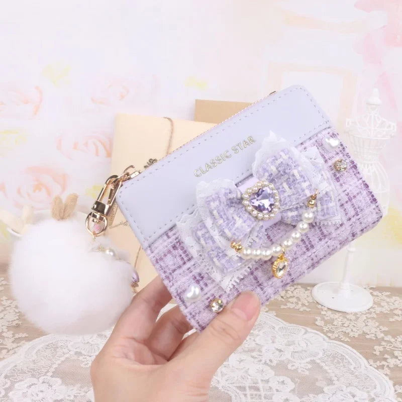 Purple quilted wallet with heart charm bow, pearl trim, and gold-tone zipper