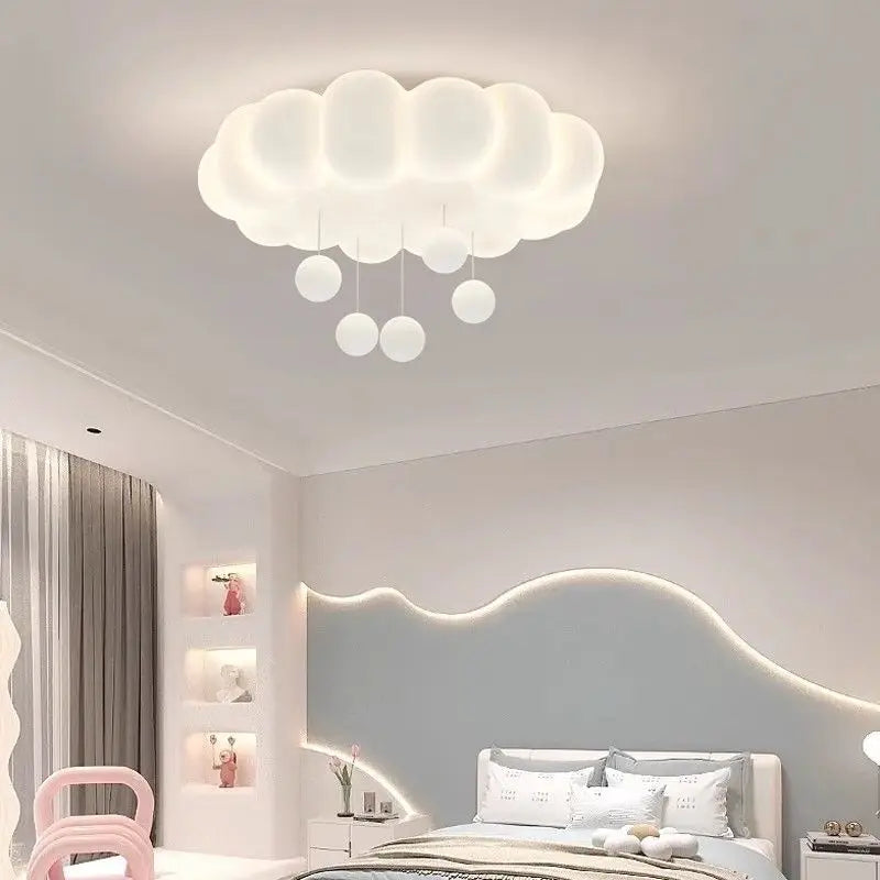 White cloud ceiling light with hanging raindrop accents in a bedroom