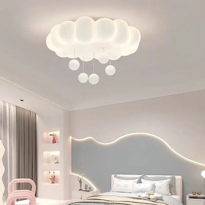 White cloud ceiling light with hanging raindrop accents in a bedroom