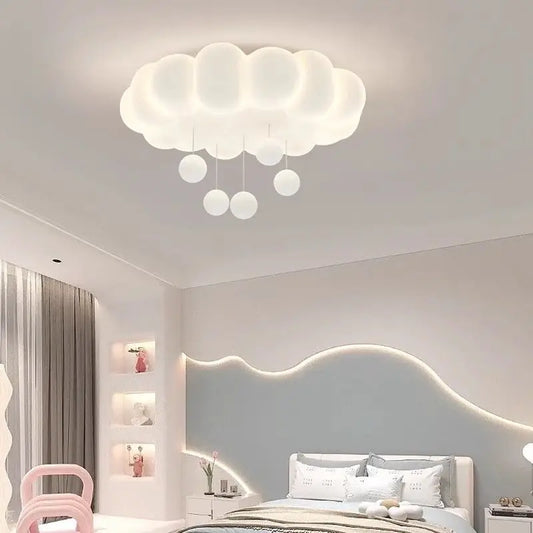 White cloud ceiling light with hanging raindrop accents in a bedroom