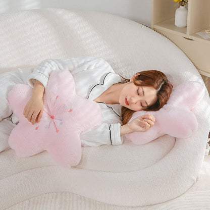 Pink cherry blossom plush pillow set, two flower-shaped cushions on a bed