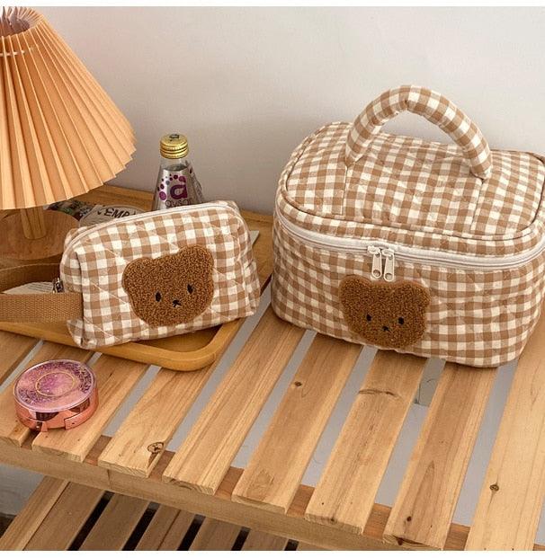 Gingham teddy bear cosmetics bag with bear face applique, handle and zip closure