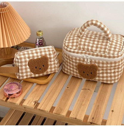 Gingham teddy bear cosmetics bag with bear face applique, handle and zip closure