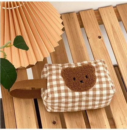 Gingham teddy bear cosmetics bag with teddy bear face applique on front, side view