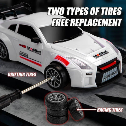 White RC drift racing car with sporty body kit and two sets of tires, 1:24 scale toy