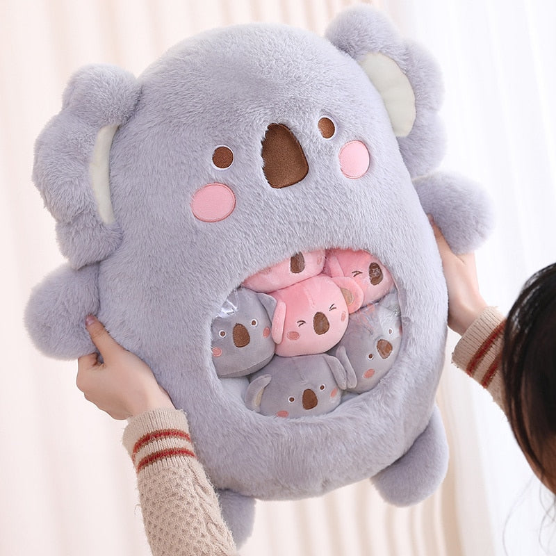 Plush animal shaped pillow in light grey, koala face design with pink nose and cheeks