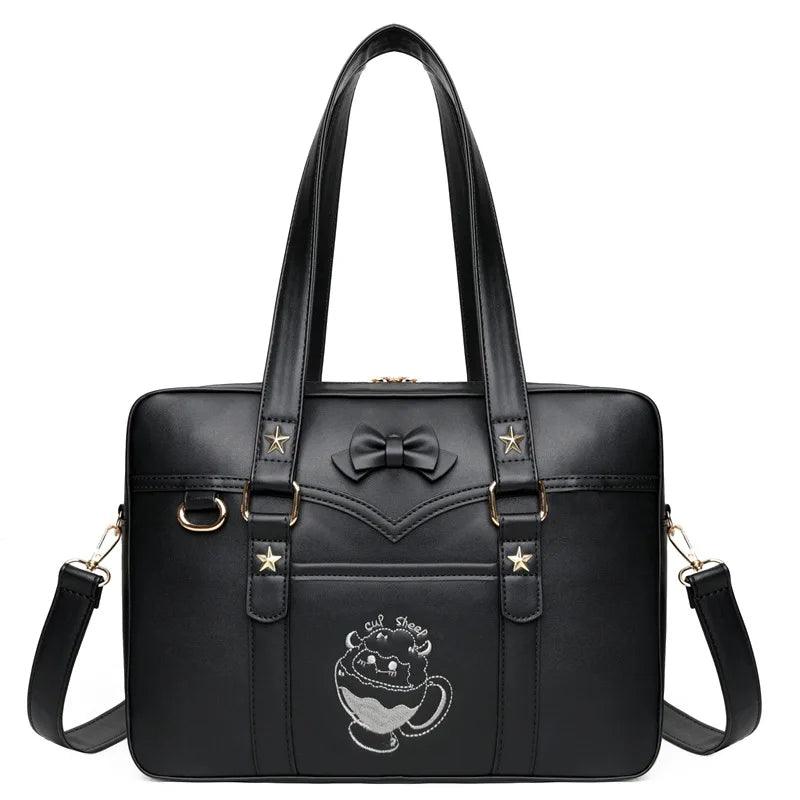 Black faux-leather messenger bag with bow emblem, star accents, and crossbody strap