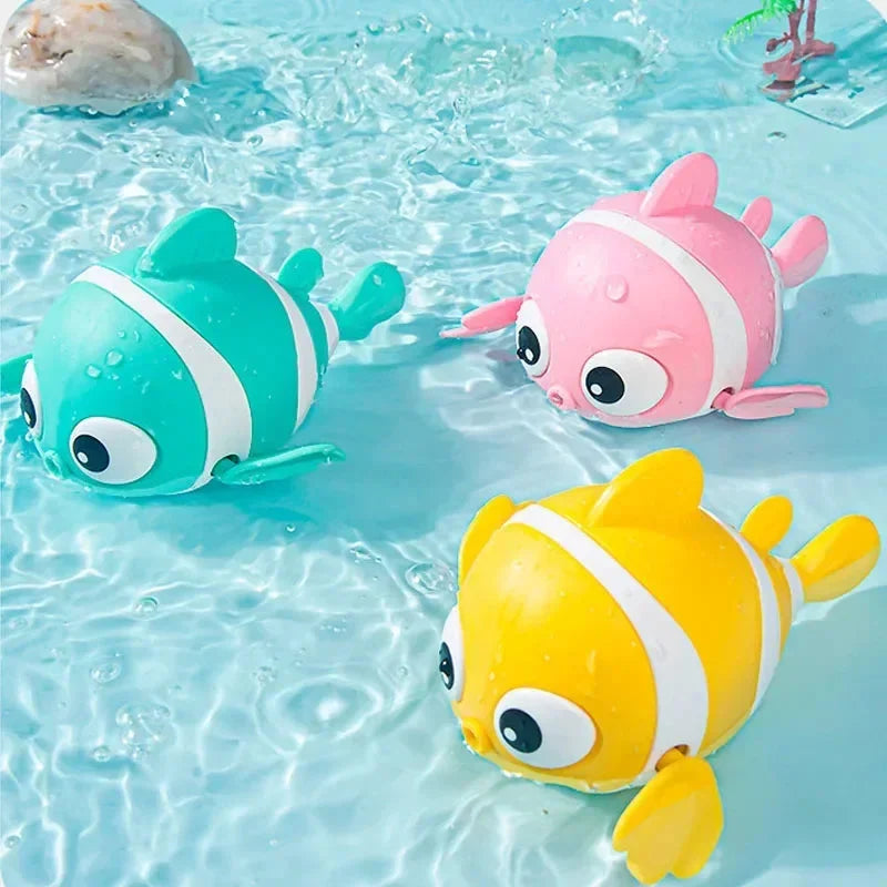 Set of three floating clown fish bath toys in teal, pink, and yellow.