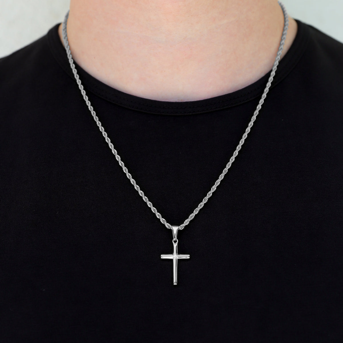 Close-up silver small cross necklace set with two layered chains and pendant cross