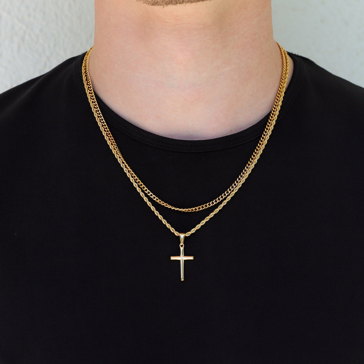 Gold layered cross necklace set with two chains and small cross pendant in view