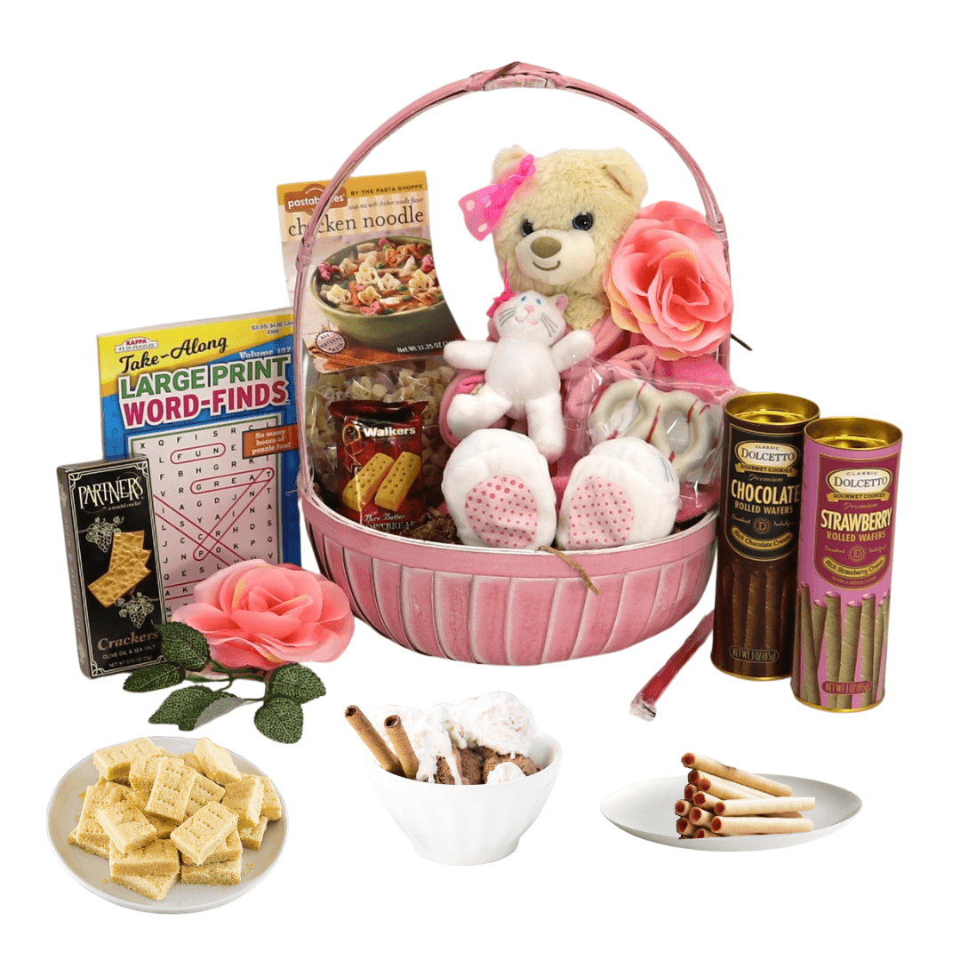 Pink gift basket with Care Bear plush, rose accents, and assorted snacks