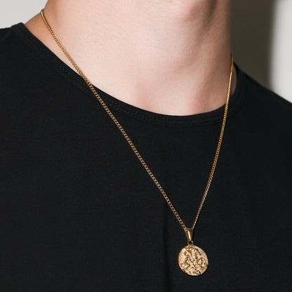 Gold rope-chain necklace with round coin pendant, angled view on neckline