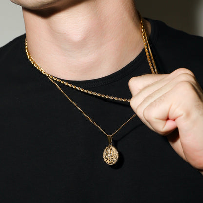 Gold coin pendant necklace with hand adjusting the chain near the collar
