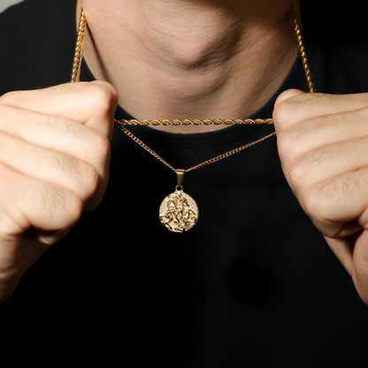 Gold rope-chain necklace set with round coin pendant; wearer holds chain ends