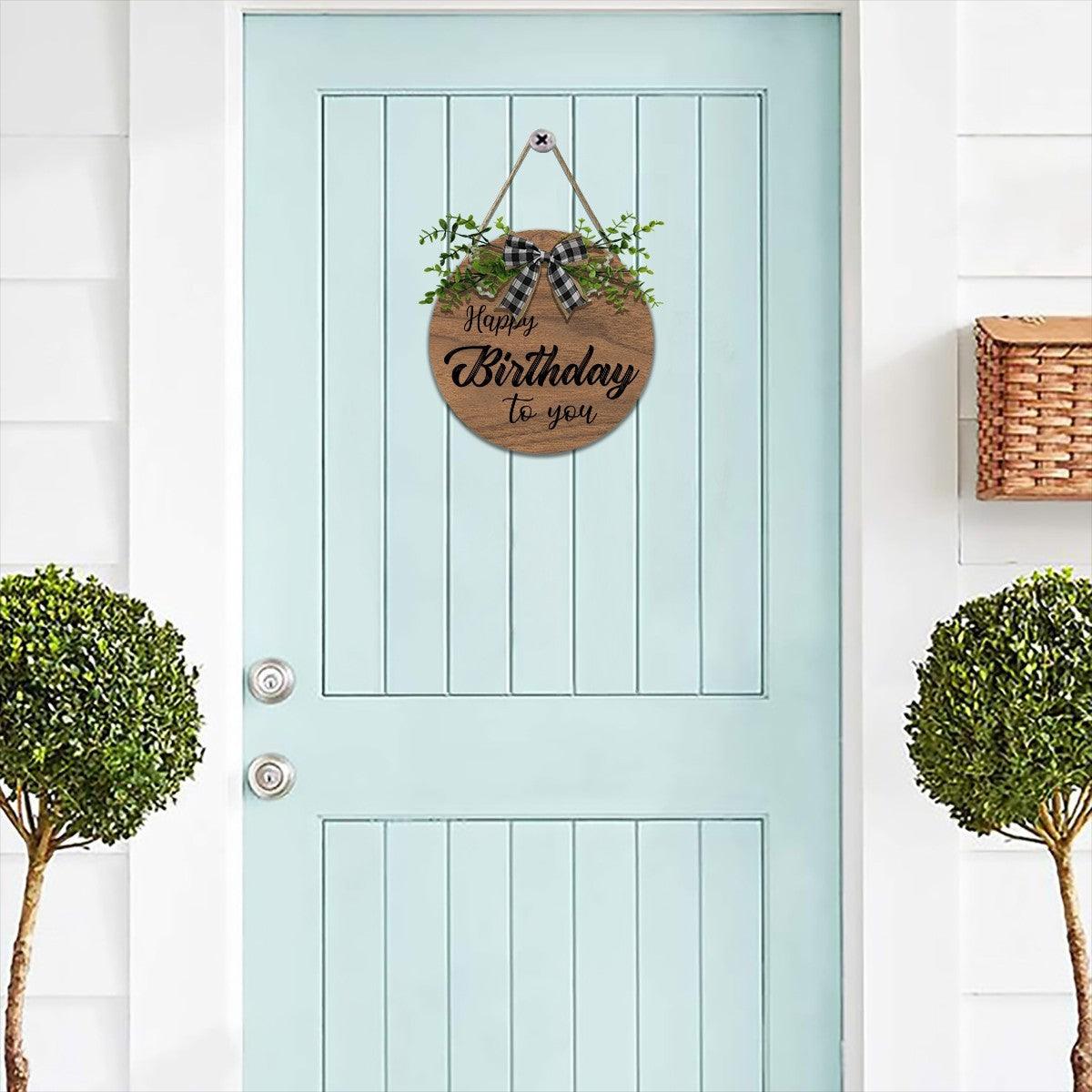 Happy Birthday wooden door sign with plaid bow, green foliage, hanging rope loop