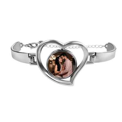 Heart-shaped photo bracelet with silver-tone frame and clasp, featuring a couple photo