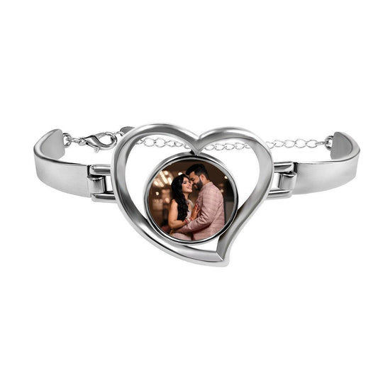 Heart-shaped photo bracelet with silver-tone frame and clasp, featuring a couple photo