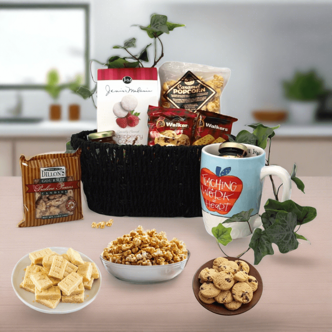 Gift basket with black woven basket, mug, and assorted snack packages and cookies.