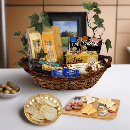 Sympathy gift basket in wicker tray with crackers, chocolate, olives and photo frame