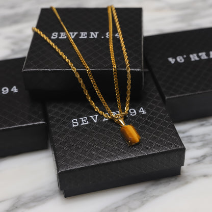 Gold tiger eye pendant necklace set on black gift boxes, layered chains with rectangular charm