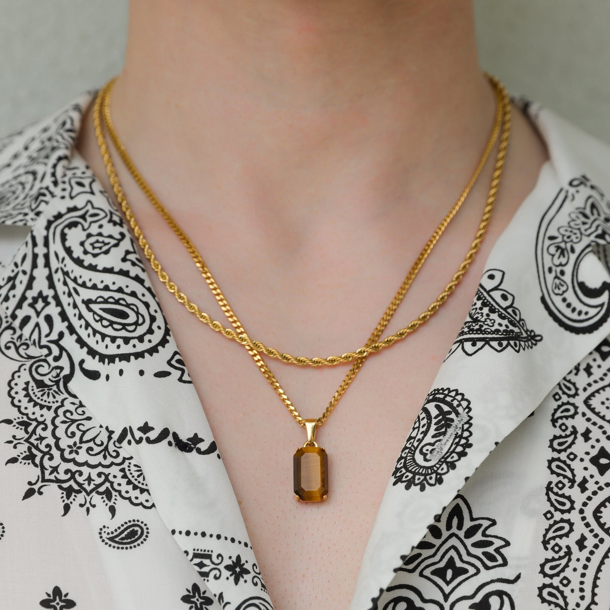 Gold tiger eye pendant necklace set with two layered chains and rectangular stone charm