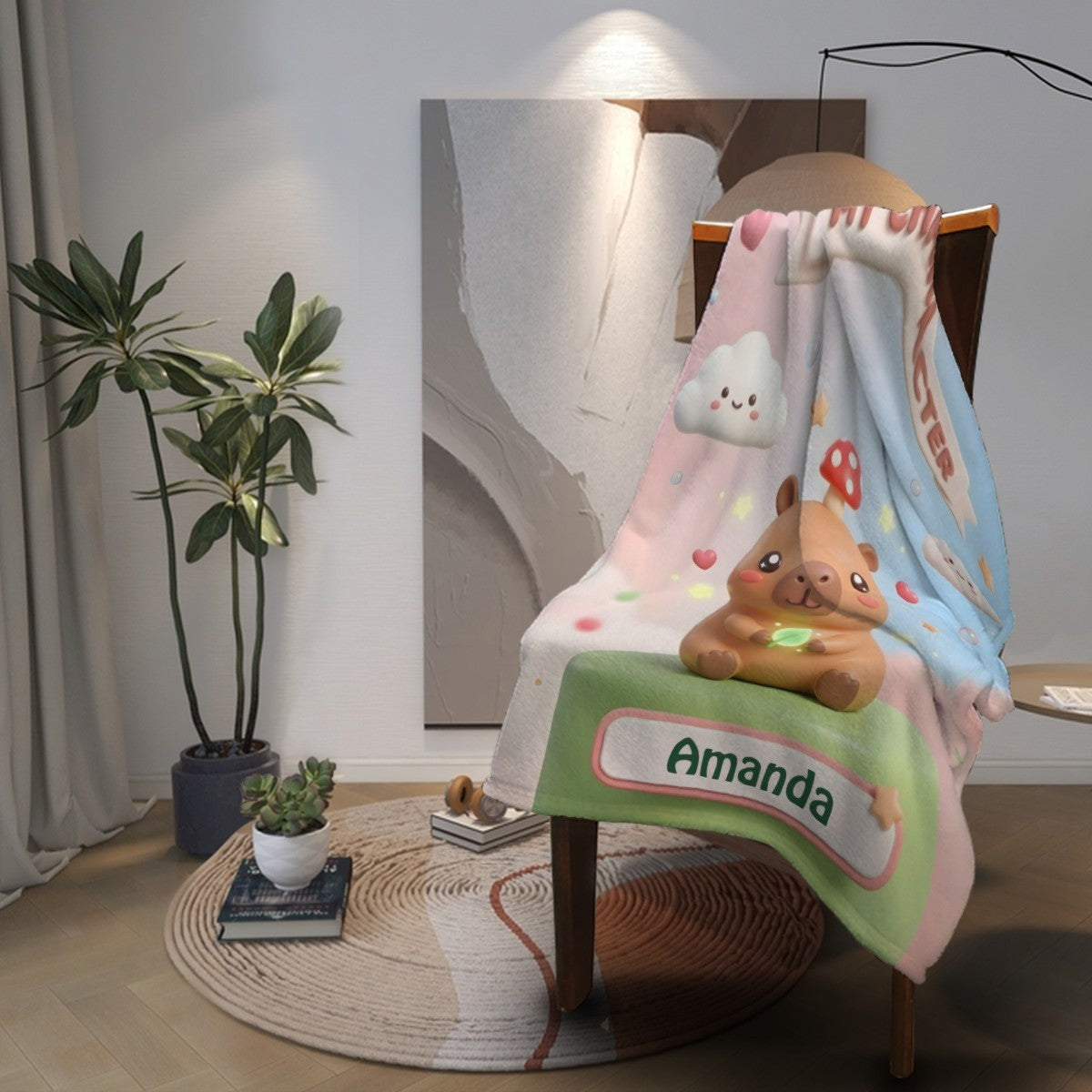 Capybara character blanket draped on chair, with Amanda label and cloud graphics
