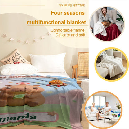 Capybara character blanket on bed with capybara, clouds, hearts, and Amanda label