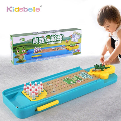 Mini desktop bowling game with blue tray, yellow ramp, and green frog launcher