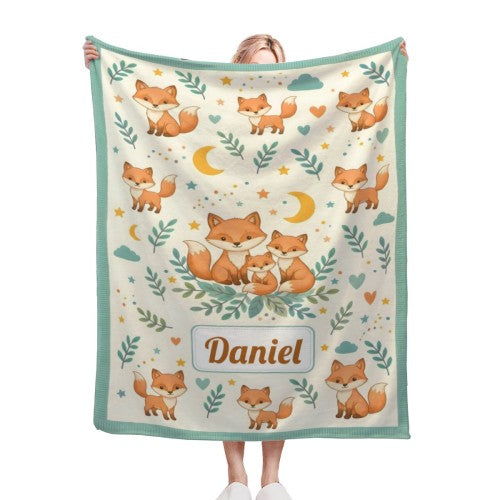 Handheld fox blanket square with teal border; woodland fox pattern and name Daniel patch.