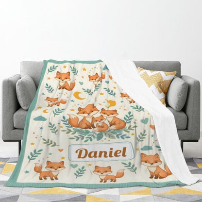Teal-trim fox blanket covering sofa; woodland fox print with name Daniel centered.
