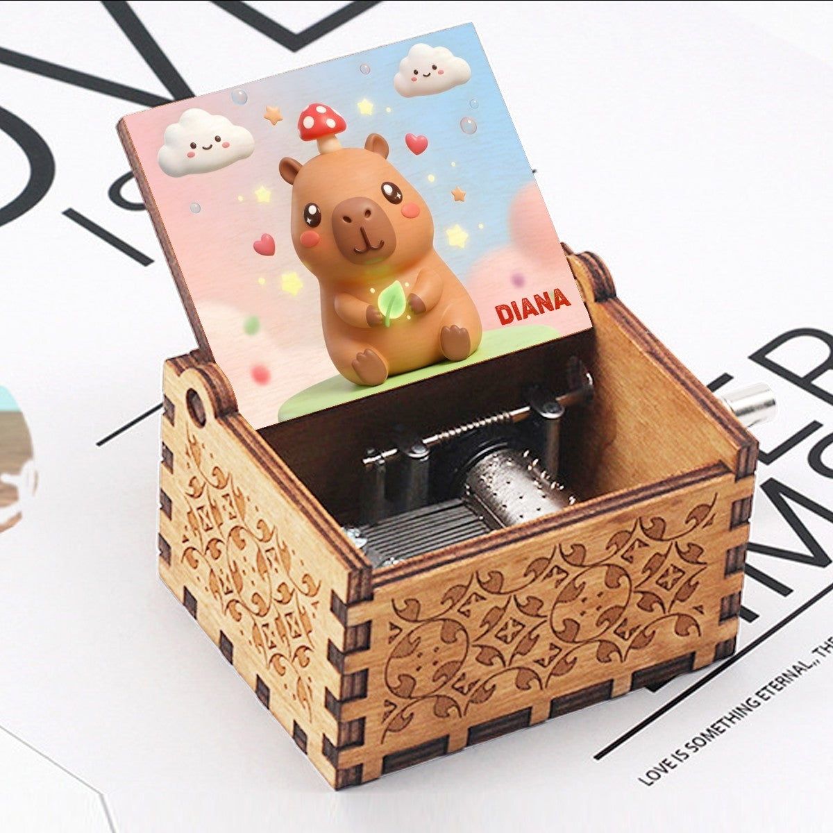 Wooden music box open with capybara character lid and visible music mechanism