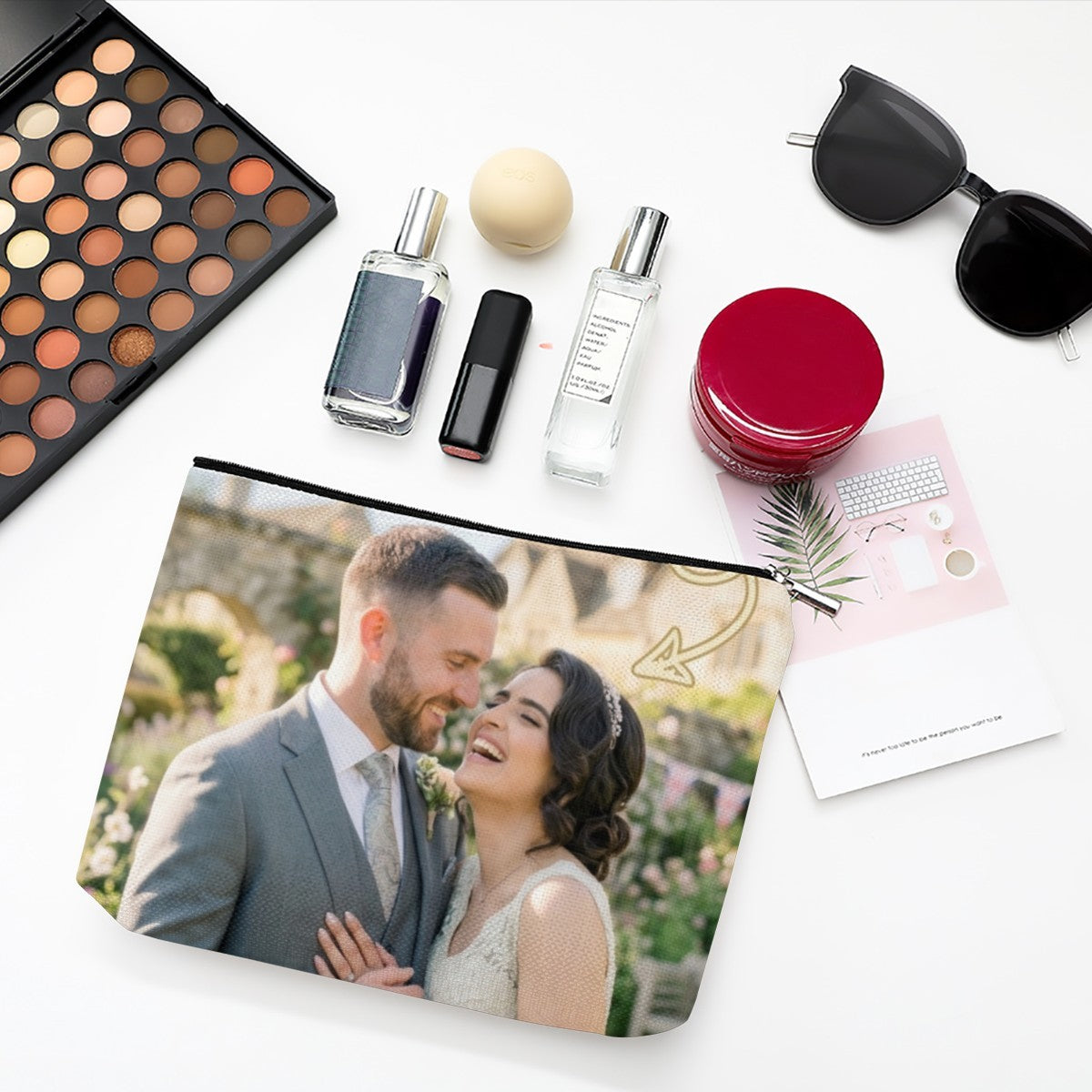 White makeup pouch with black zipper and couple photo print, angled view