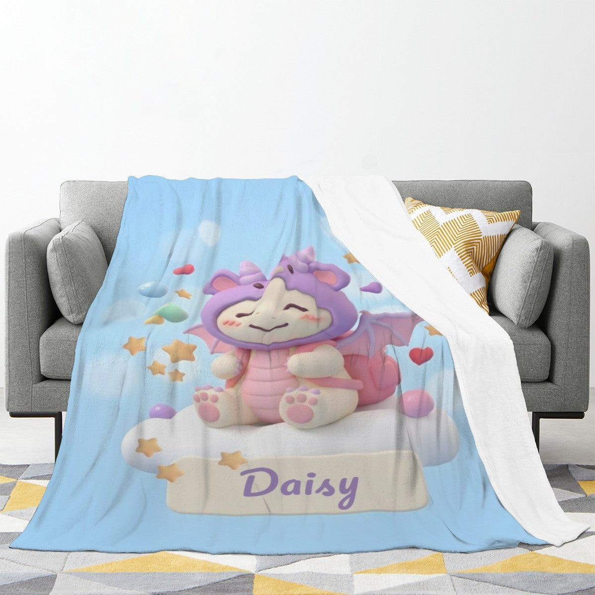 Light blue throw blanket draped on a couch, showing character art and “Daisy”