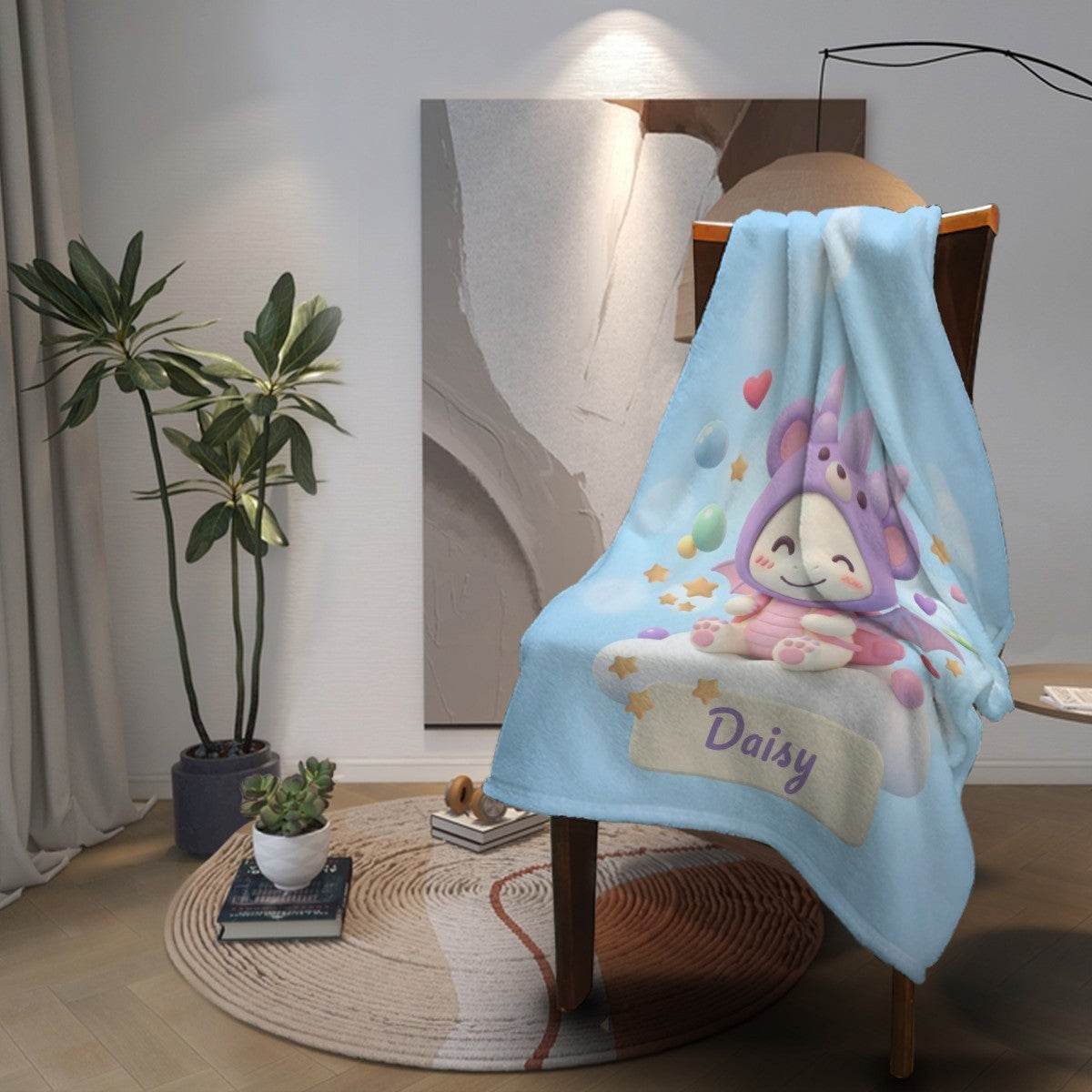 Light blue blanket on a chair with character illustration and “Daisy”
