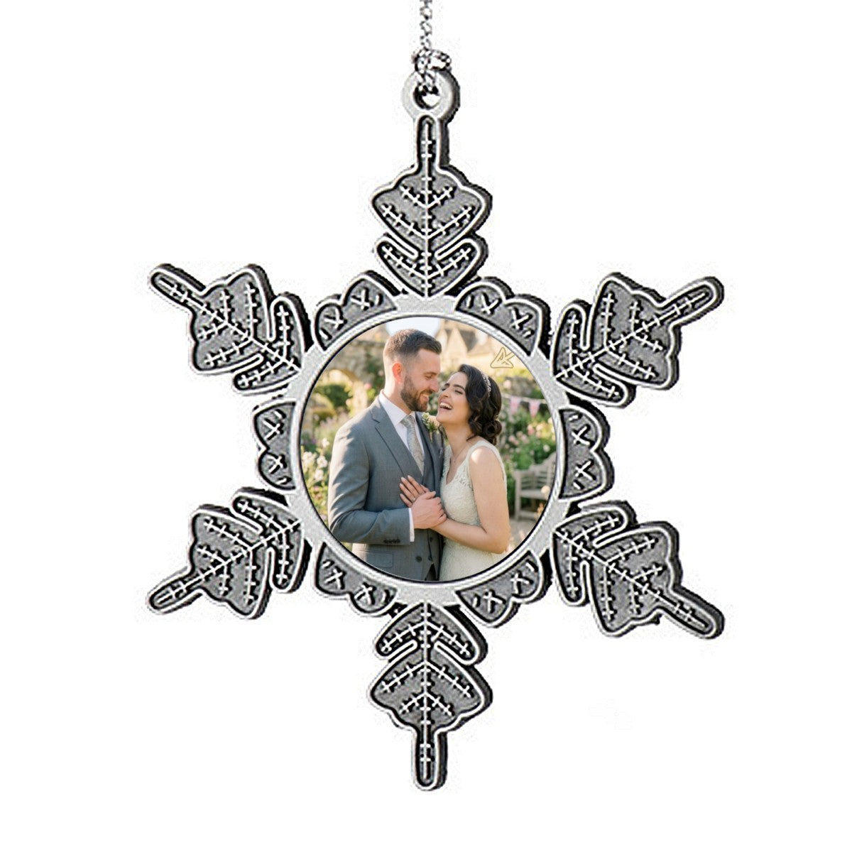 Hanging star-shaped photo ornament with circular couple picture and chain loop.