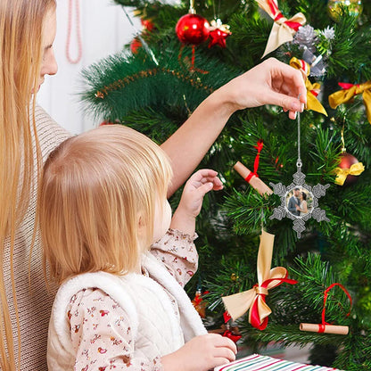 Star-shaped photo ornament on a Christmas tree, with a circular couple picture.