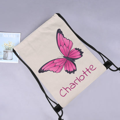 Butterfly drawstring bag with pink butterfly print and 'Charlotte' on cream fabric.