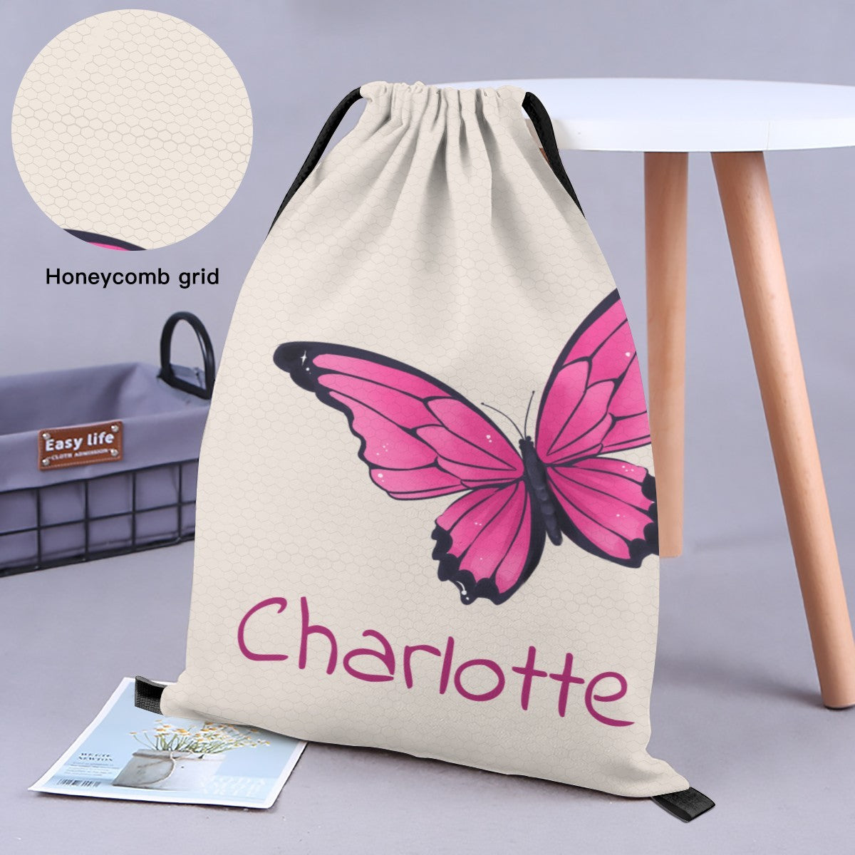 Cream butterfly drawstring bag with pink butterfly and 'Charlotte' front panel.