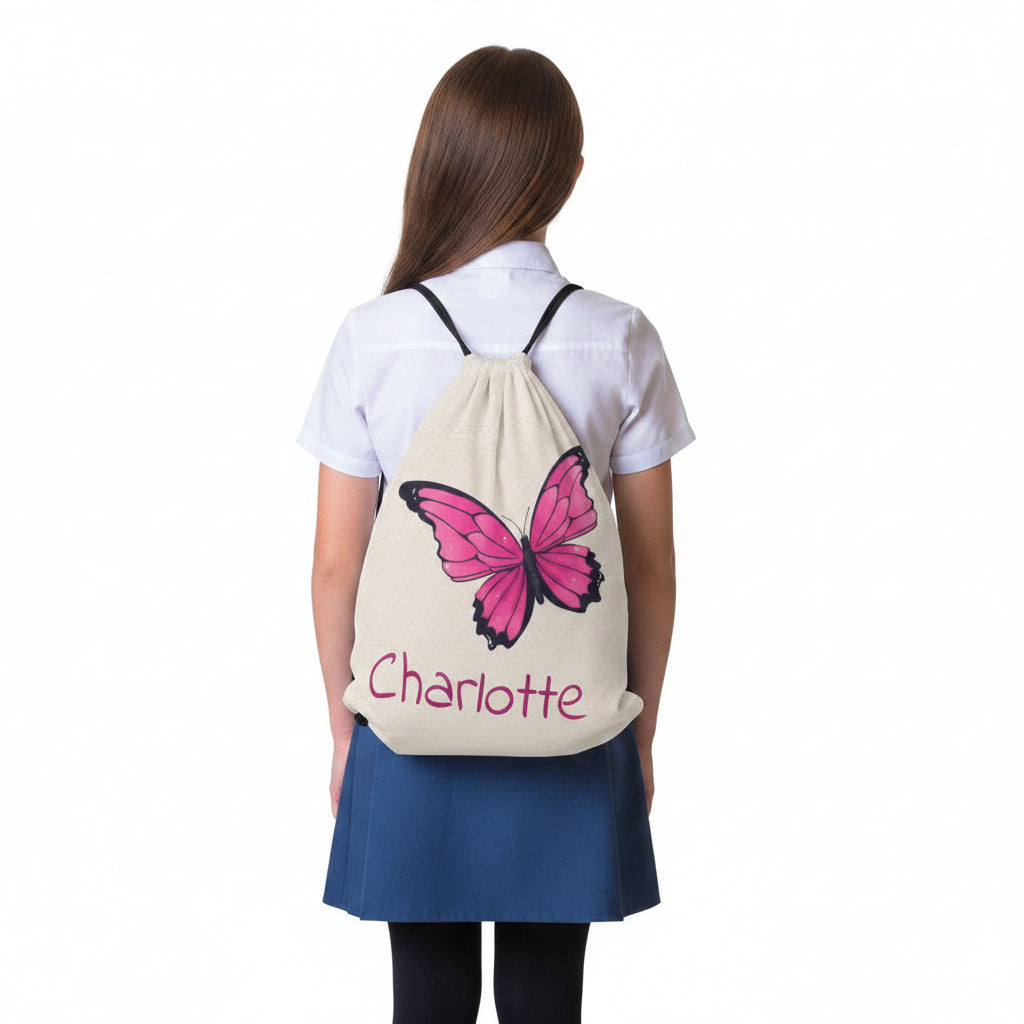 Butterfly drawstring bag worn on back with pink butterfly and 'Charlotte' text.