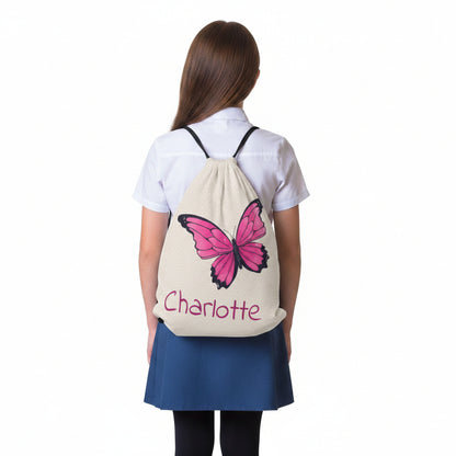 Butterfly drawstring bag worn on back with pink butterfly and 'Charlotte' text.