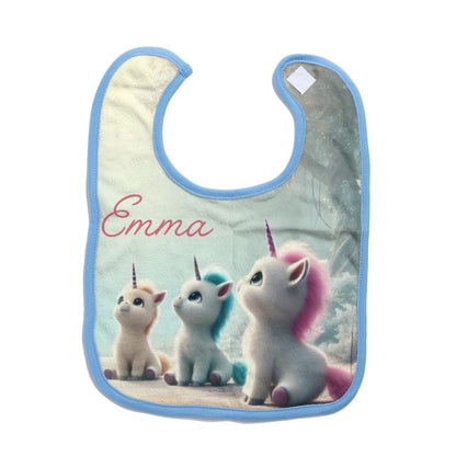 Personalized baby bib with three unicorns and “Emma” on mint fabric, blue trim.